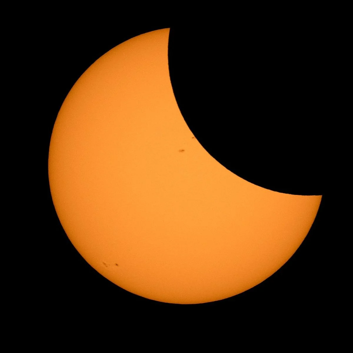 Partial Eclipse Ingress and Sunspot Groups photographed by NASA